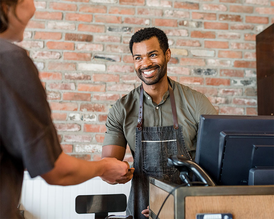 Cashier-small A group of people visiting booths at a career fair event